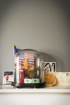 Collection of objects from vacations and travel with glass dome