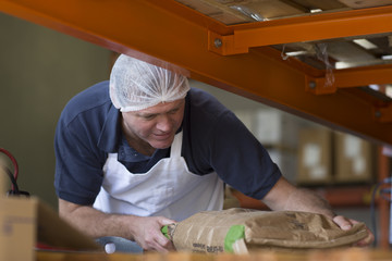 Factory worker handling parcel