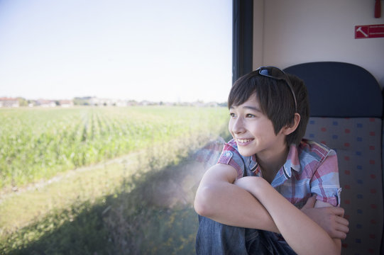 Boy looking out of train window