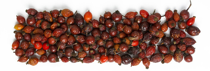 Dog roses and essential oil, bunch of dog rose, Herbal tea, Different types Rosa canina hips and hawthorn, dry goji berries, briar powder in wooden spoon. chinese herbal medicine selection in wooden