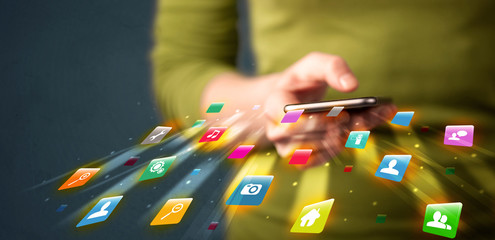 Man holding smartphone with technology application icons