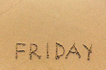 Friday - written manually on the texture of sea sand.