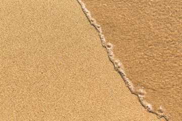 Beach sand texture with a slight wave.