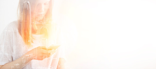 Closeup photo of stylish girl wearing blank t-shirt and looking cell phone. Double exposure,...