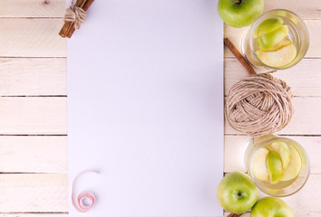 White background with apple and cinnamon drinks