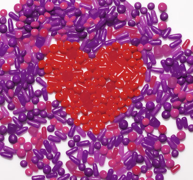 Still life of heart shaped by red candy
