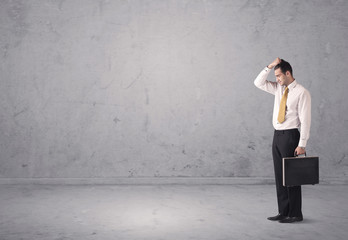 Young businessman standing confused