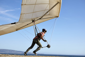 Hang glider pilot taking off
