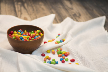 Multicolor candies a wooden vase