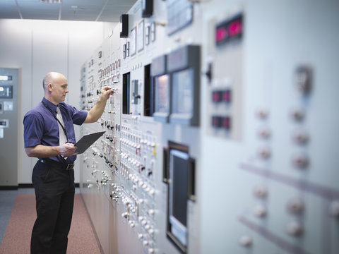 Engineer Inspecting Nuclear Power Station Control Room Simulator