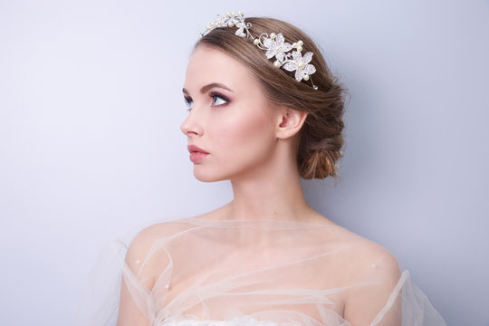 beautiful woman  bride with tiara on head  on bright background , copy space.
