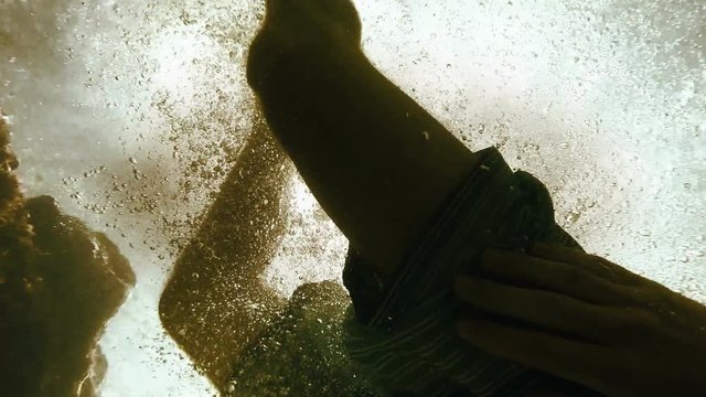 An underwater footage of a man plunging into the warm waters of the sea