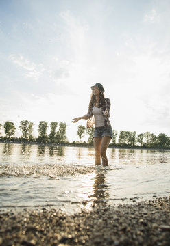 Young woman paddling in lake