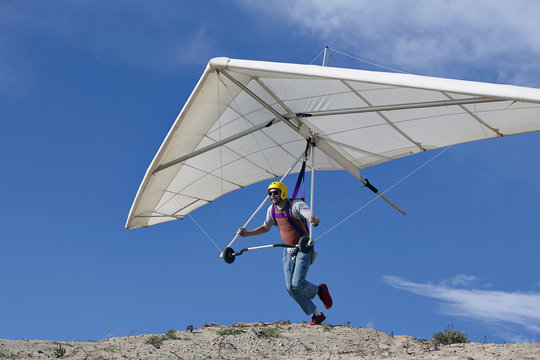 Hang glider pilot taking off