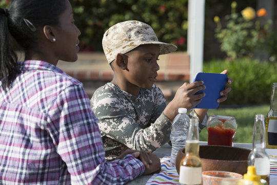 Boy playing on digital game at homecoming party