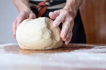 Baker makes bread on the table