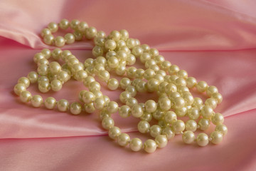 Pearl Necklace on delicate Pink silk background