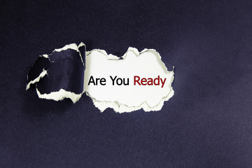The question Are You Ready appearing behind torn paper