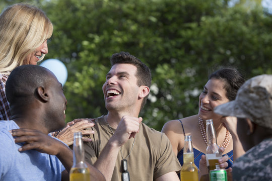 Male soldier celebrating with family and friends at homecoming party