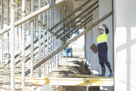 Site manager reaching to checking work on construction site