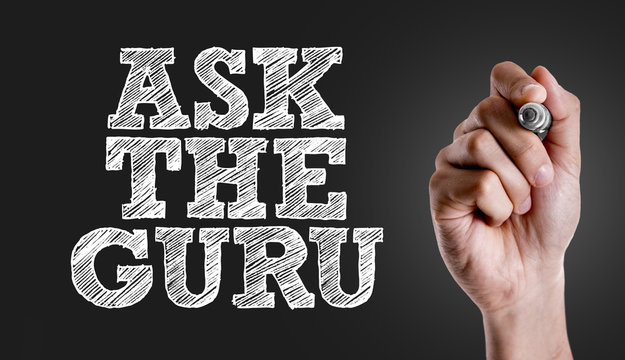 Hand writing the text: Ask The Guru