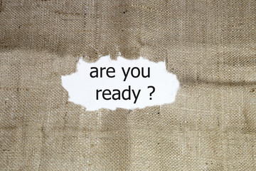 the question are you ready word written under brown torn burlap