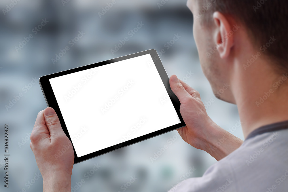 Aufkleber Tablet with isolated screen for mockup in man hands. City life in background. Isolated device screen for design, interface promotion.