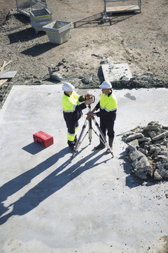 High angle view of site manager and surveyor on construction site