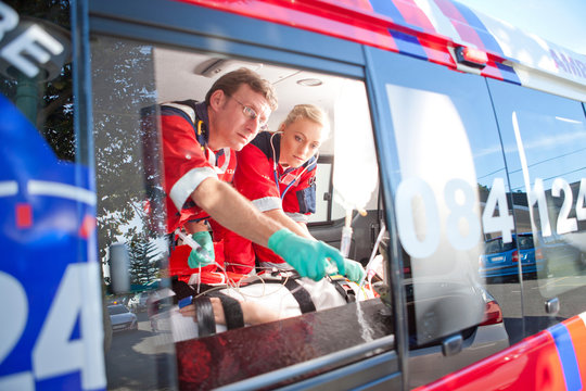 Paramedics monitoring patient in ambulance