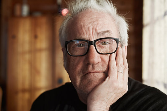 Senior man with grey hair and glasses