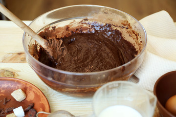 Preparing dough for chocolate pie on table close up