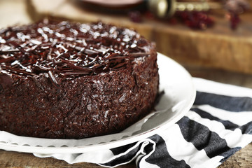 Tasty chocolate cake on wooden background