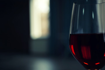 Glass of red wine on blurred background