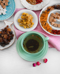 Cup of tea with aromatic dry tea on wooden background