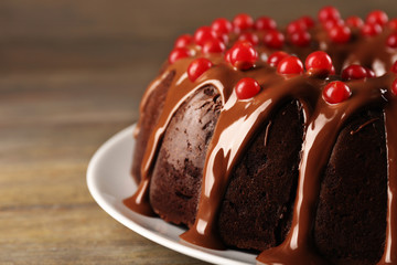 Chocolate cake with snowball tree berries on a table