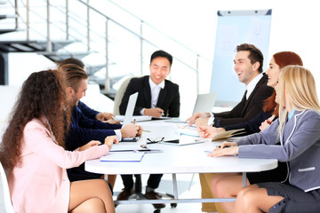 Young colleagues sitting at the business meeting in the office