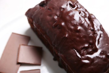 Chocolate cake with icing on white table