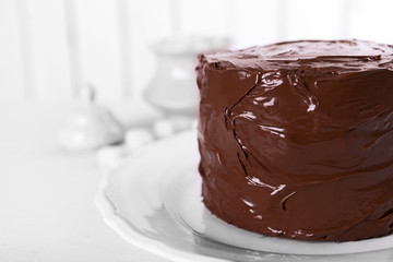 Tasty chocolate cake on light background