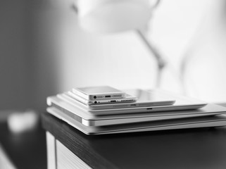 Pile of electronic gadgets on the table. Communication and technology concept