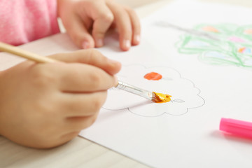 Obraz na płótnie Canvas Child drawing tree with bright paints on paper, closeup