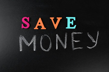 Obraz premium Save money concept on a blackboard background