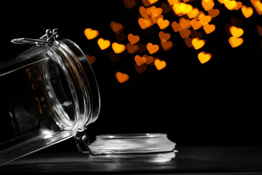 Miracle of love from glass jar on black background