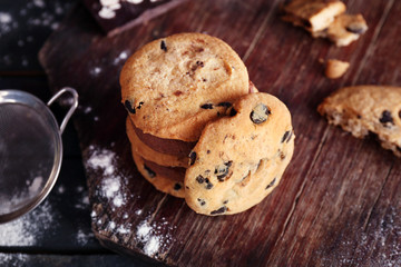 Chocolate chip cookies on cutting board on wooden background