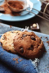 Fototapeta na wymiar Chocolate chip cookies on a jeans napkin on dark grey background