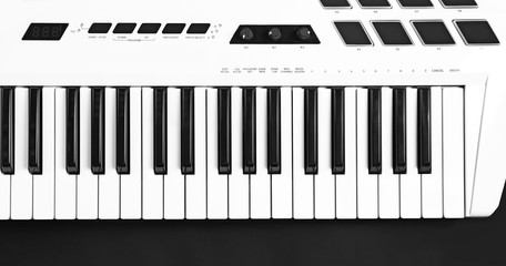 Fototapeta premium Keyboard of synthesizer on black background
