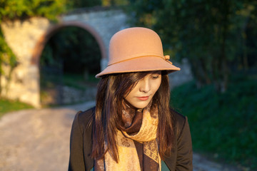 Spring and autumn portrait of cute young woman with hat