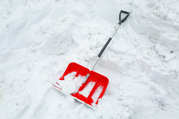 Winter concept. Red shovel for snow removal