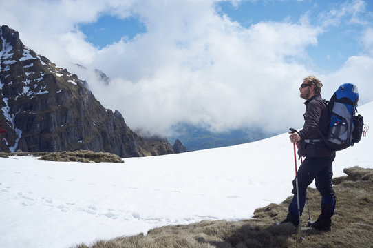 Mature man standing in snow, Bucegi Mountains, Transylvania, Romania