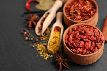 Assorted spices on black table background