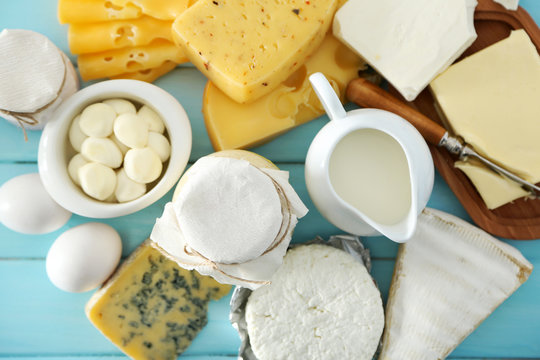 Set of fresh dairy products on blue wooden table, close up